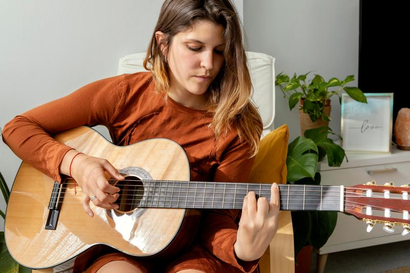 woman-home-playing-guitar