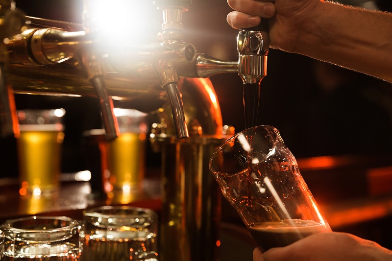 close-up-bartender-pouring-beer