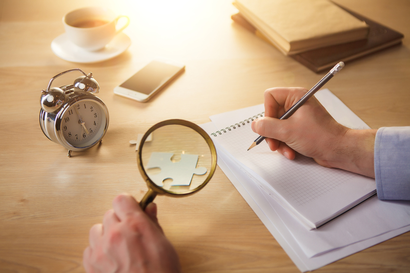 male-hands-with-pencil-magnifying-glass